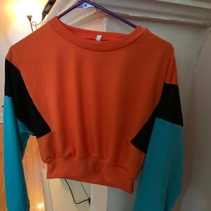 A neon orange, blue and black crop top